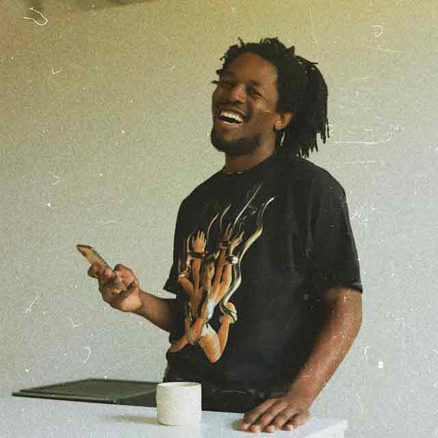 Daniel looking up from his phone grinning