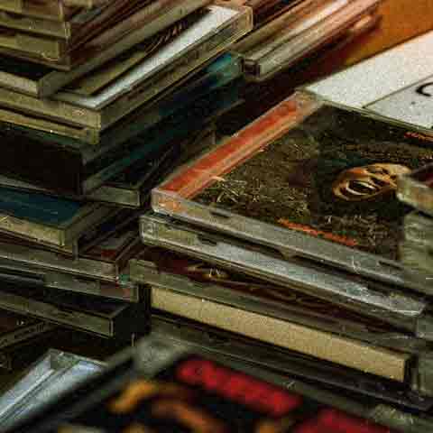 piles of cds on a table