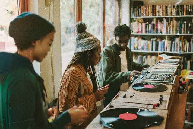 Group of people in Recusrsive Records listening to music and socialising during a record of the week event
