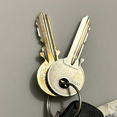 Set of 2 metal door keys on a keyring